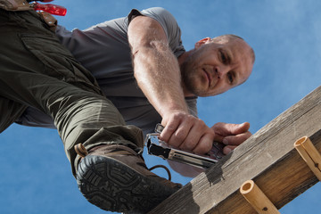 Soft focus construction worker repairing house.