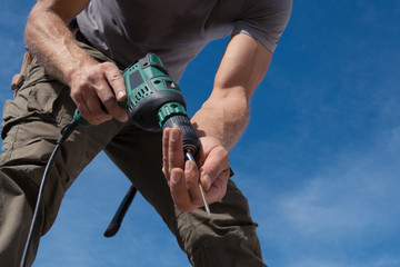 Construction worker repairing the roof of a house