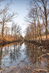 Silhouettes landscape view sunset Water reflection, a canal in a large nature reserve, Fochteloerveen, The Netherlands
