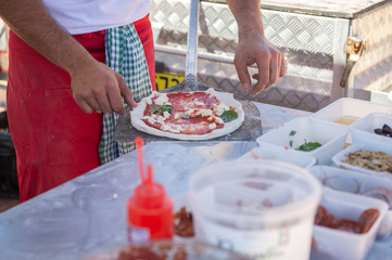 Gourmet chef making wood fired pizza