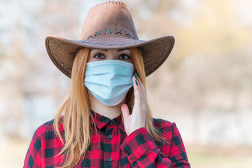 American Woman in mask on street because of air pollution and epidemic in city. Protection against virus, infection. 