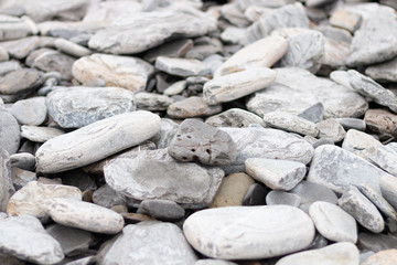 rare gray  shaped stone pierced with other stones and rocks around. Wallpaper