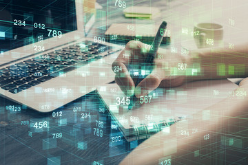 Multi exposure of writing hands on background with data solution hologram. Technology concept.