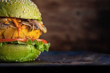 piece of veggie burger. rusty baking stick. wooden background. copyspace. horizontal orientation. close up