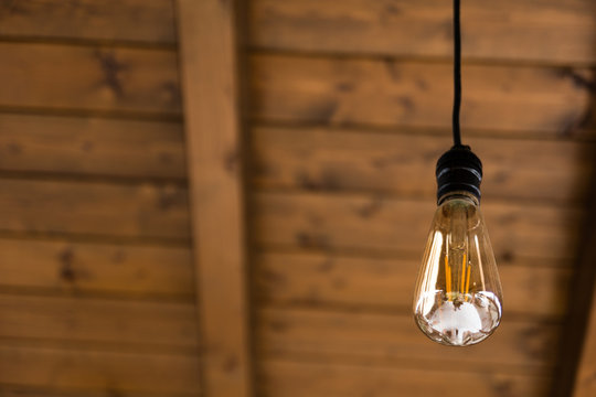 Vintage light bulb on wooden background