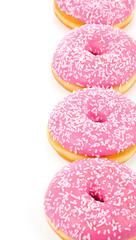 donuts in rosa glaze, lie in a row on a white background