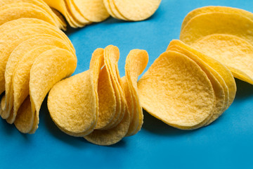 Patatas fritas sobre fondo azul liso. Vista superior y de cerca