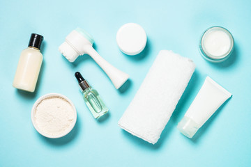 Skin care product on blue background top view.