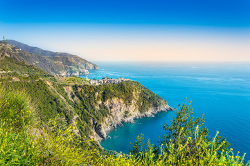 Fototapeta na wymiar Corniglia, Cinque Terre - beautiful small village with colorful buildings on the cliff overlooking sea. Cinque Terre National Park with rugged coastline is famous tourist destination in Liguria, Italy