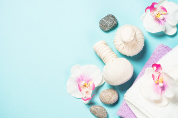 Spa herbal compressing balls on blue background.