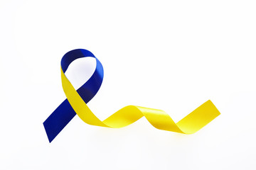 Blue and yellow ribbon on white background. World down syndrome day. Awareness ribbon.