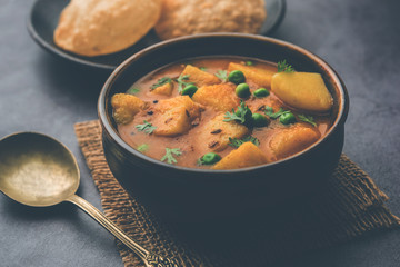 Aloo Puri or Potato curry with fried Poori, popular Indian breakfast / lunch / dinner menu.