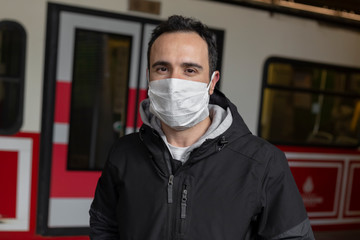 The adult man wanders the streets of Istanbul with a mask to prevent infectious diseases.