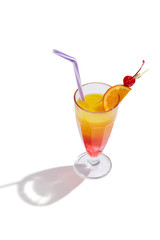 Sex on the Beach cocktail with ice cubes is contained in a milkshake glass with a straw, an orange slice and a cherry on the stick. The showy illustrative picture is made on the white backdrop.