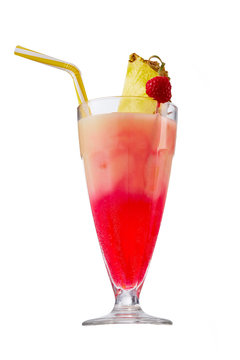 Sex on the Beach cocktail with ice cubes is contained in a milkshake glass with pineapple slice, a straw and a raspberry on the stick. The showy illustrative picture is made on the white backdrop.
