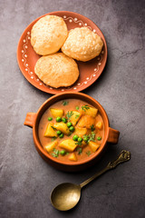 Aloo Puri or Potato curry with fried Poori, popular Indian breakfast / lunch / dinner menu.