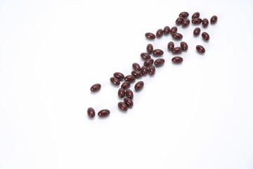 The reddish brown capsule is on a white background