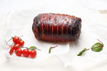 Roasted pork roulade. A plate with an appetizing dish. Application suggestion. Culinary photography, food stylization.