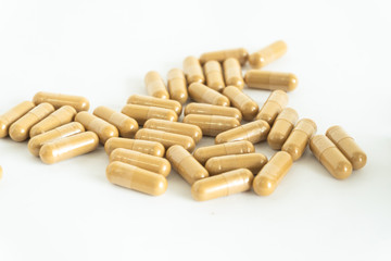 brown medicine herb pill on white background