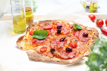 Take-away pizza. Appetizing crunchy Italian pizza. A plate with an appetizing dish. Application suggestion. Culinary photography, food stylization.