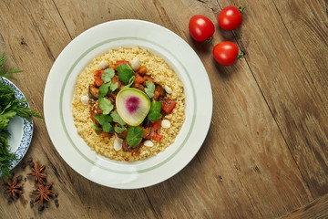Juicy and unusual Israeli chicken steak (Pargiyot) with a side dish of polenta, corn porridge. Grilled chicken. Wooden background