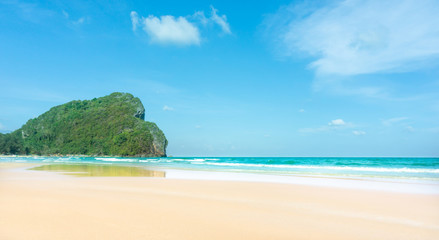 Clean white beach golden brown sand and blue sea under clear blue sky in a sunny day