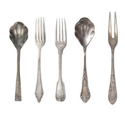 Collection of beautiful old vintage forks, spoons and knife isolated on white background. Top view. Retro silverware.