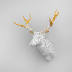 Fototapeta premium Lots of shiny threads intertwined in the shape of a voluminous deer head on the wall. Christmas concert. 3D illustration