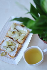 healthy toast with pears, green tea and flowers for Breakfast for the woman you love