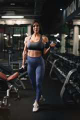 Fototapeta na wymiar Fitness woman on training. Young woman in the gym.