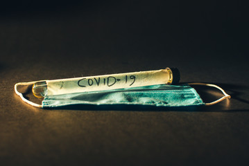 Covid-19 Virus test label on test tube and a surgical mask
