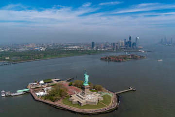 statue of liberty and new york city manhattan downtown aerial view © Andrea Izzotti