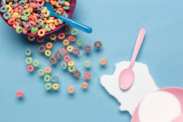 Bowl of cereals and splash of milk with pink spoon