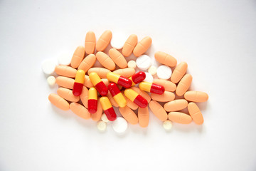 Stack of different pills on white background