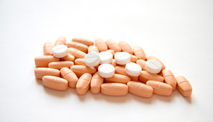 Stack of different pills on white background