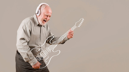Excited senior playing imaginary guitar