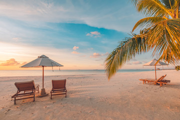 Obraz premium Beautiful beach. Chairs on the sandy beach near the sea. Summer holiday and vacation concept for tourism. Tranquil scenery, relaxing beach, wonderful tropical landscape design. Boost up color process