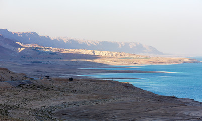 Fototapeta na wymiar Panoramic view of the Dead Sea, whose level falls by one meter per year against the background of the Judean mountains. Israel, Middle East