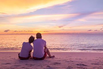 The image of two people in love watching sunset. Tropical beach landscape, seascape and sky