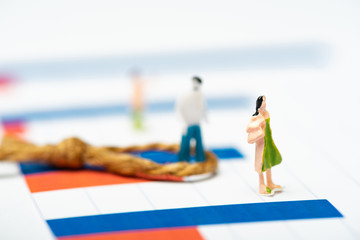 Obraz premium Selective focus of plastic people figures with noose on charts on white surface, concept of equality