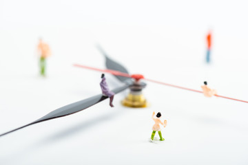 Selective focus of people figures near arrows of watch on white background, concept of senescence