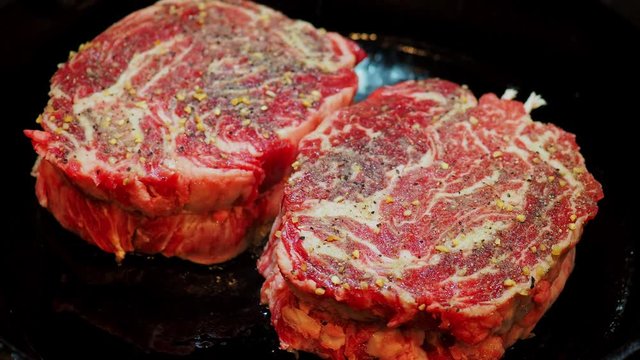 Close up shot of frying the delicious Prime Rib Eye Cap on a cast iron pan