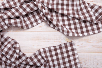 Fototapeta na wymiar Tablecloth napkin on wood texture. Rustic background. top view.