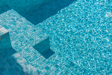 Sunny swimming pool detail on the bright summer day. Summer vacation or holiday concept
