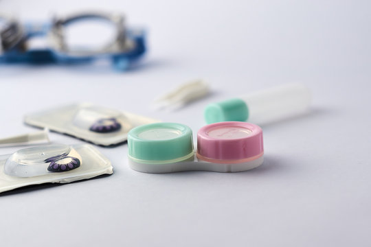 Contact lens with optometrist equipment tools on white background