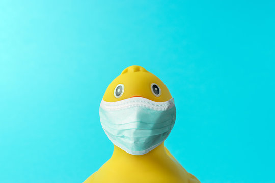 Creative composition with Yellow rubber duck with virus mask. Minimal Corona virus outbreak. Holiday concept.