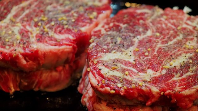 Close up shot of frying the delicious Prime Rib Eye Cap on a cast iron pan