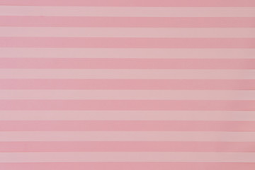 Abstract paper background in yellow and pink stripes. Horizontal shot.