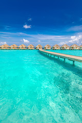 Maldives beach resort panoramic landscape. Amazing summer landscape with lagoon, blue sea and wooden jetty to water bungalows. Luxury vacation and travel landscape background