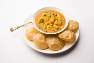Aloo Puri or Potato curry with fried Poori, popular Indian breakfast / lunch / dinner menu.